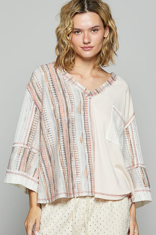 3/4 sleeve v-neck with patchwork detailing and contrast stitching