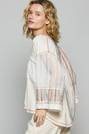 3/4 sleeve v-neck with patchwork detailing and contrast stitching