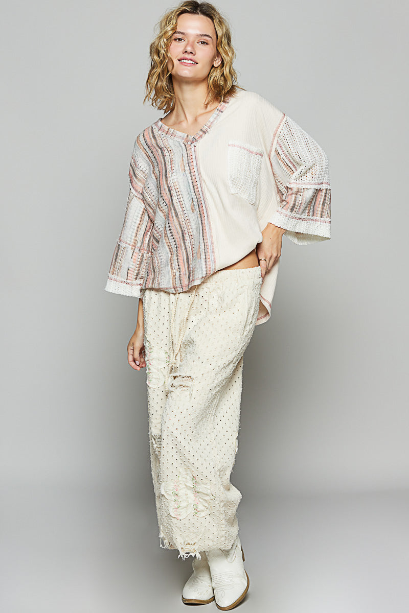 3/4 sleeve v-neck with patchwork detailing and contrast stitching