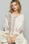 3/4 sleeve v-neck with patchwork detailing and contrast stitching