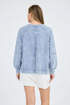Washed v-neck exposed seam long sleeve knit top