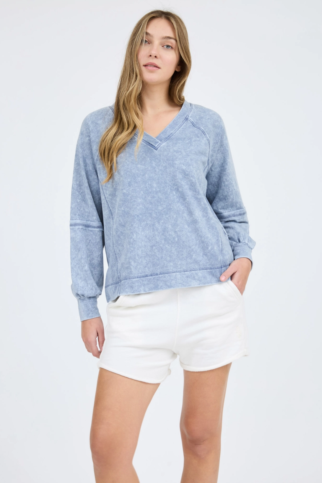 Washed v-neck exposed seam long sleeve knit top