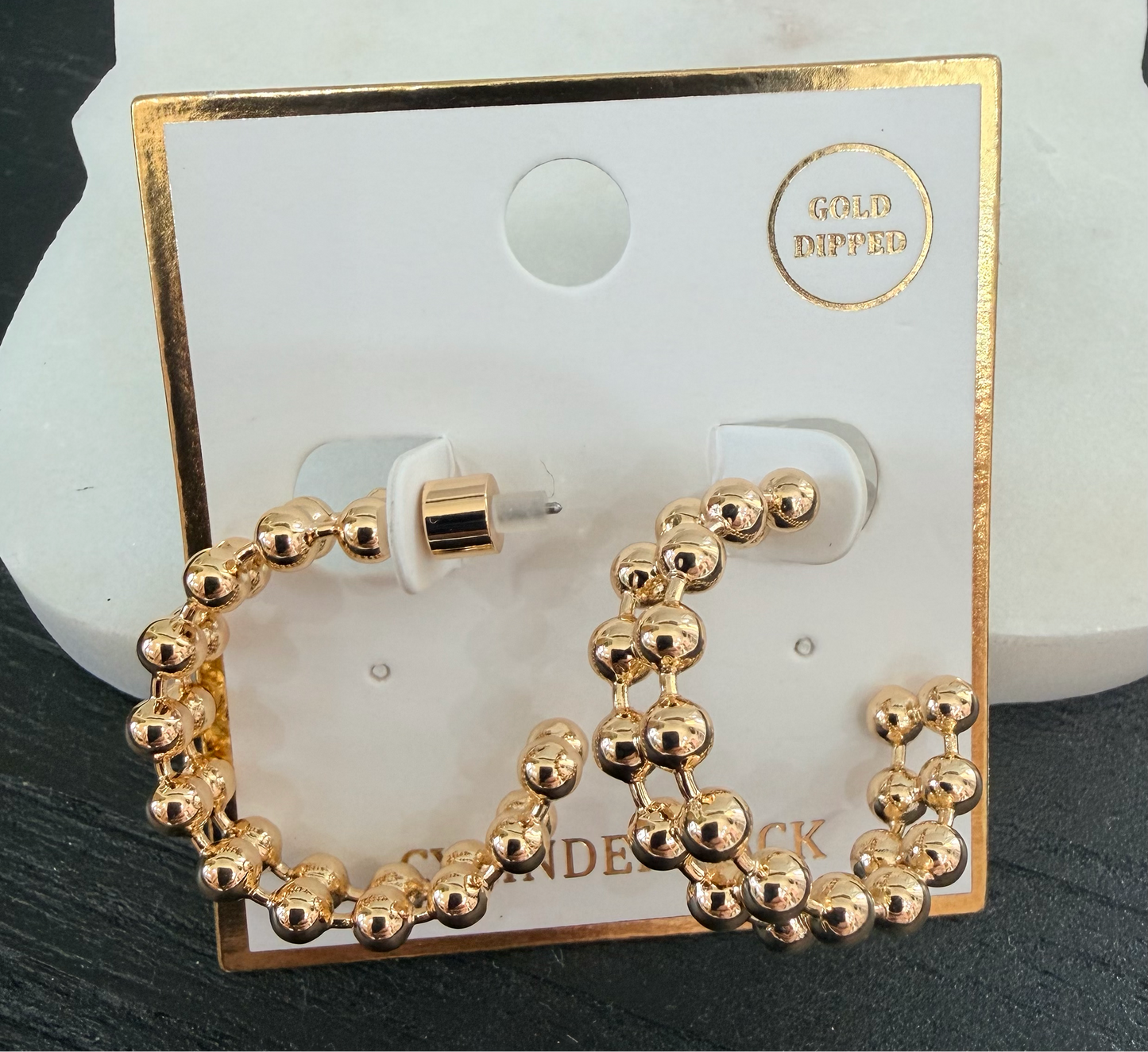 Gold beaded hoop earrings on a display card with 'Gold Dipped' text.