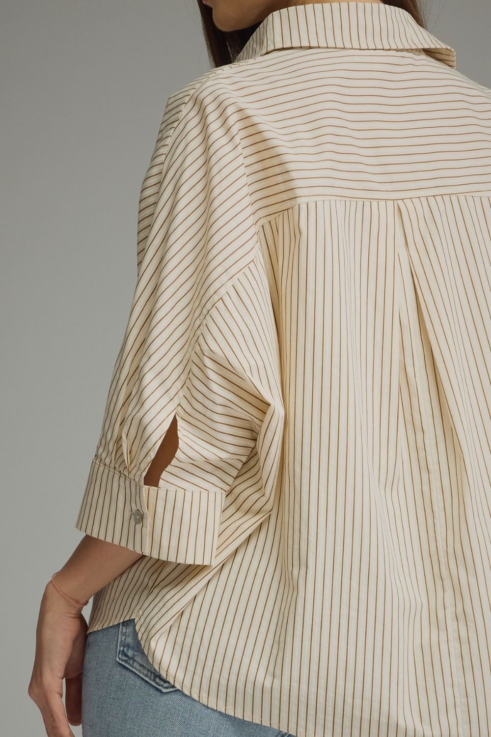 Stripe ¾ sleeve top featuring front pocket detail