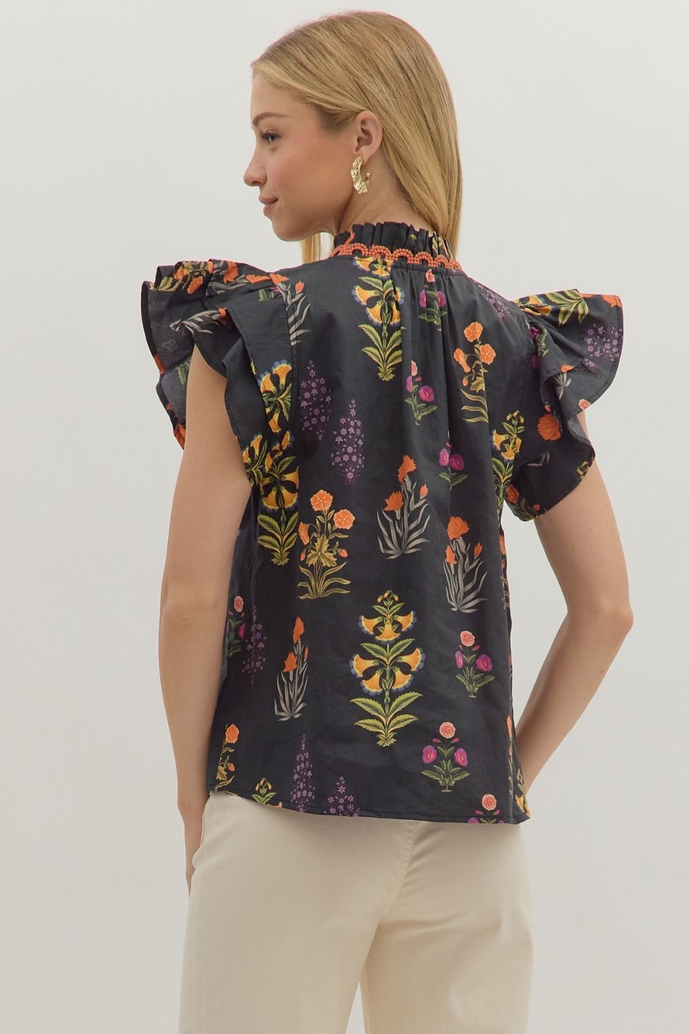 Botanical print short flutter sleeve top featuring pintuck bodice with embroidered trim V-neck