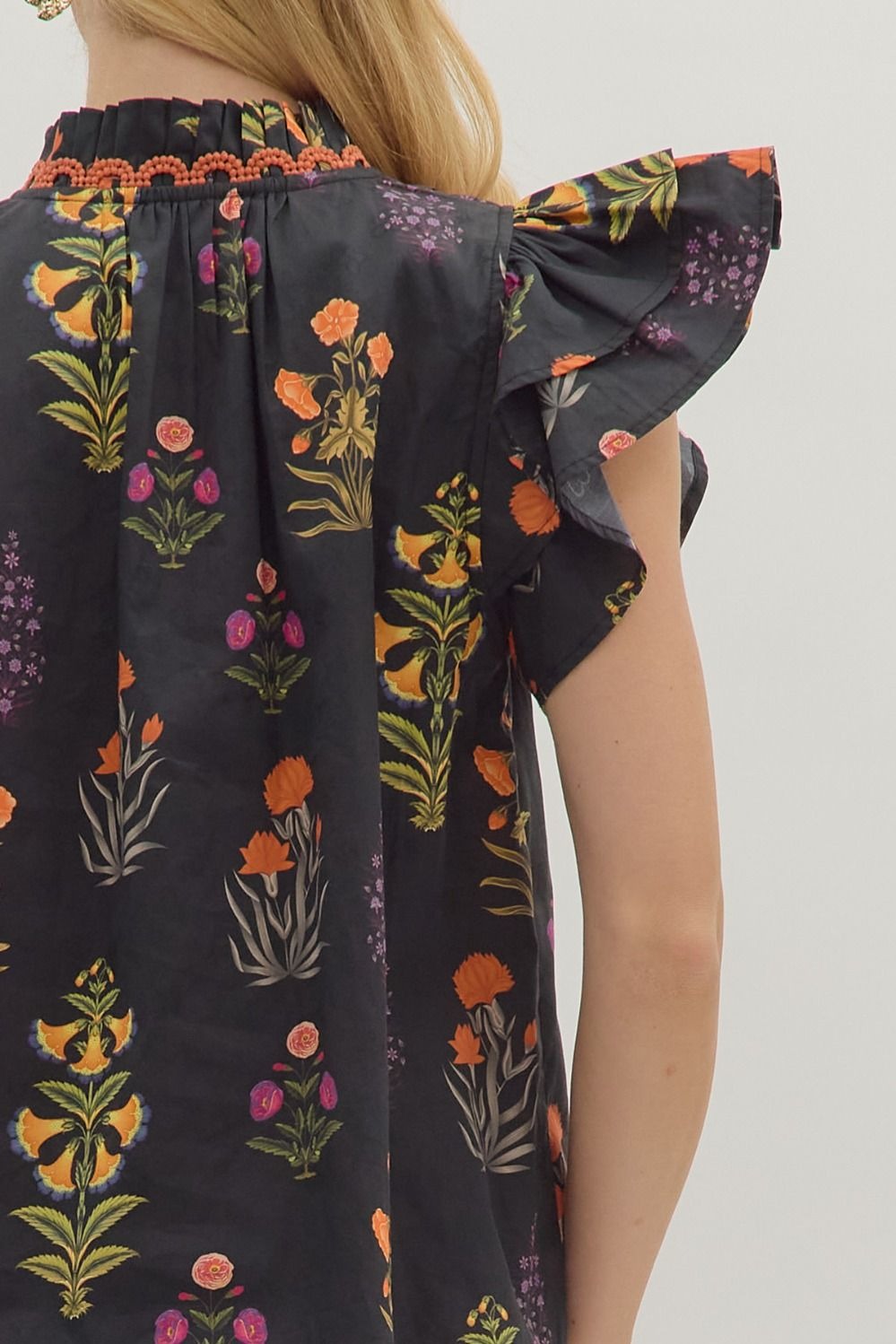 Botanical print short flutter sleeve top featuring pintuck bodice with embroidered trim V-neck