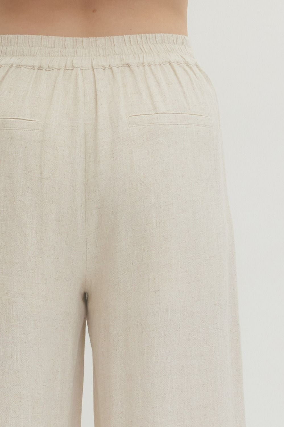 Solid woven pants featuring front patch pockets and zip-fly with button closure