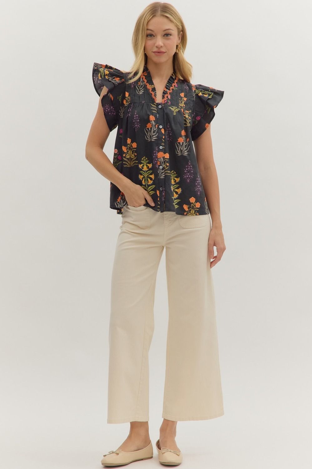 Botanical print short flutter sleeve top featuring pintuck bodice with embroidered trim V-neck