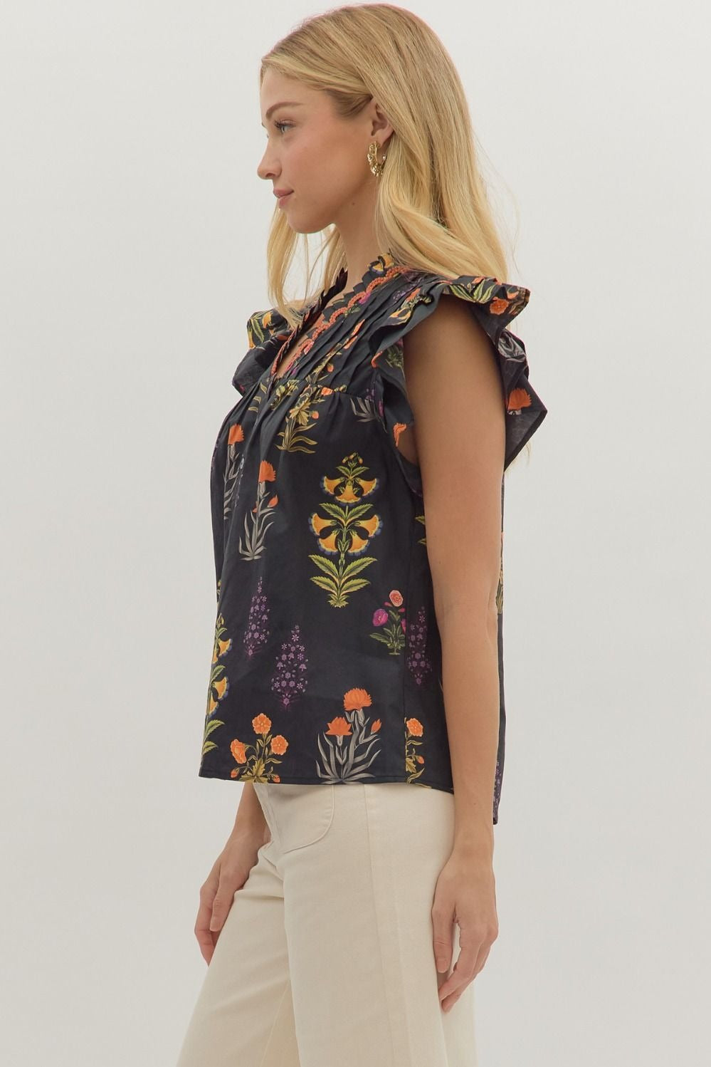 Botanical print short flutter sleeve top featuring pintuck bodice with embroidered trim V-neck