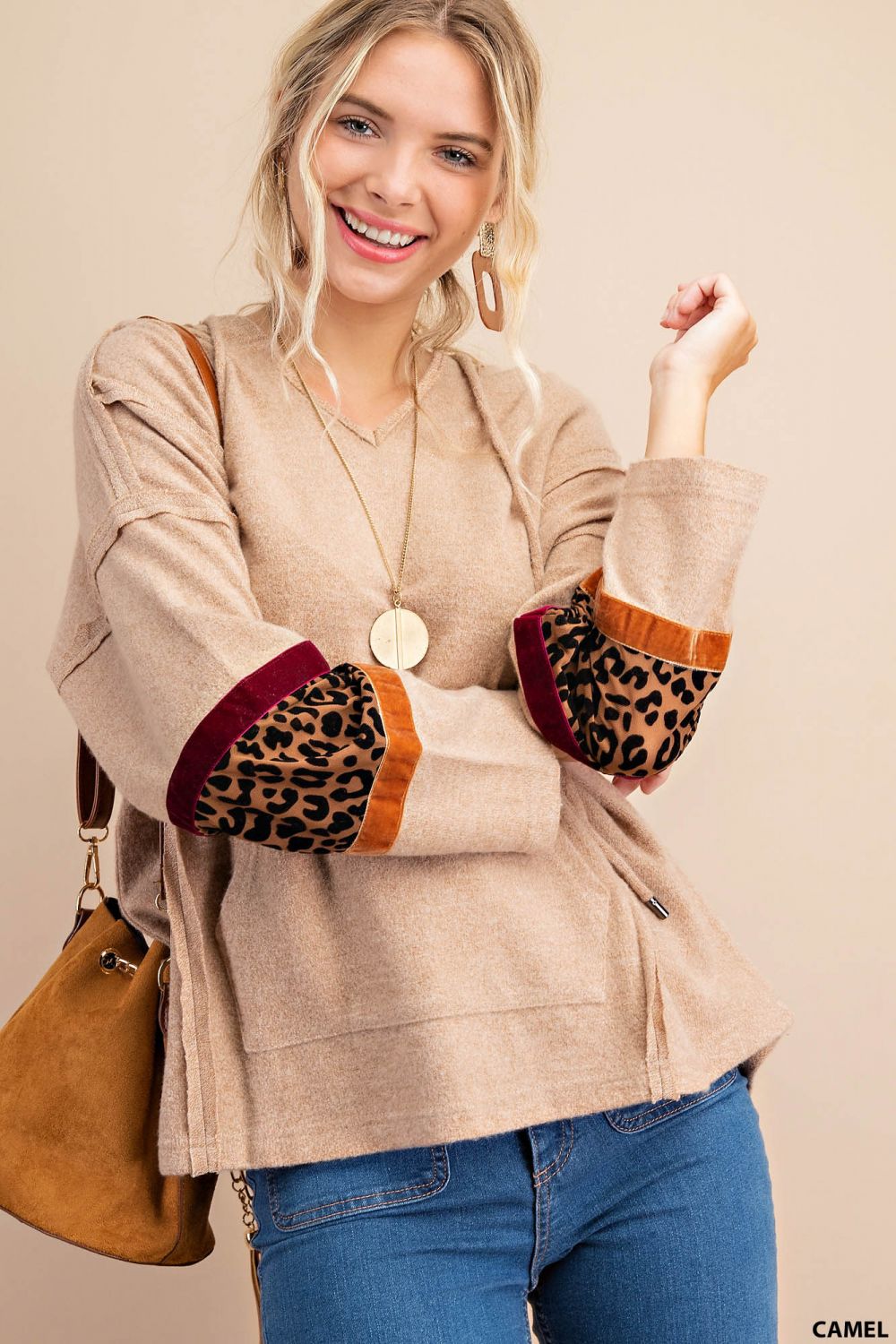 Distressed raw hem hoodie with animal print patch and front pockets Ivy and Pearl Boutique