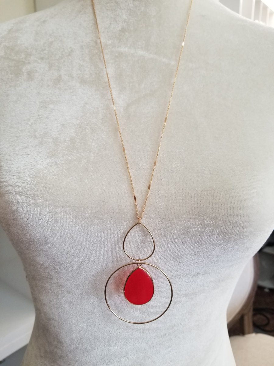 Red teardrop dangle earrings with golden trim Ivy and Pearl Boutique