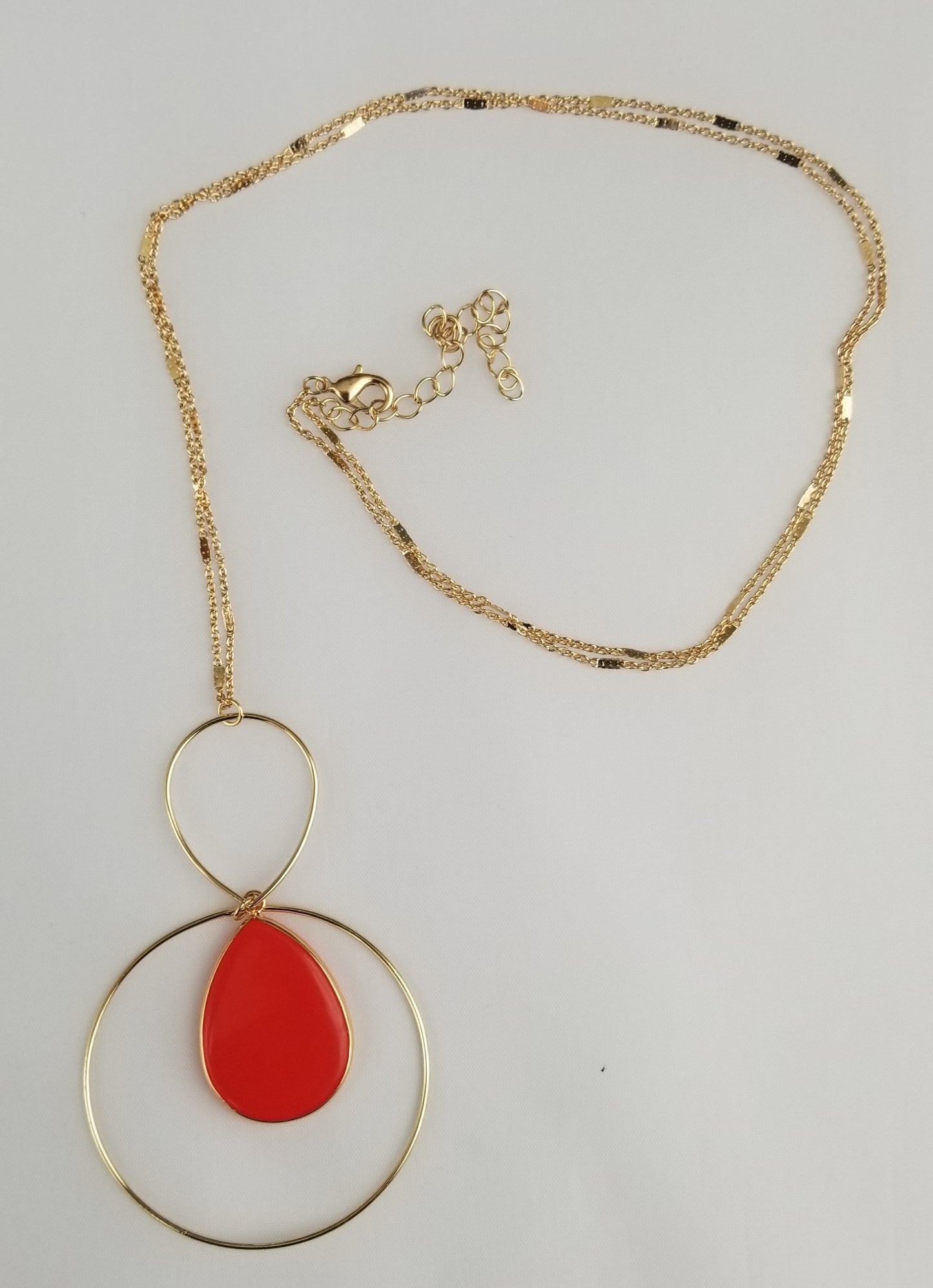 Red teardrop dangle earrings with golden trim Ivy and Pearl Boutique