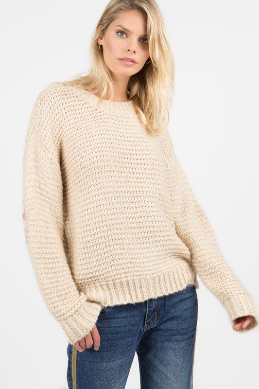 Basic ribbed pullover sweater with multi-colored floral elbow patch