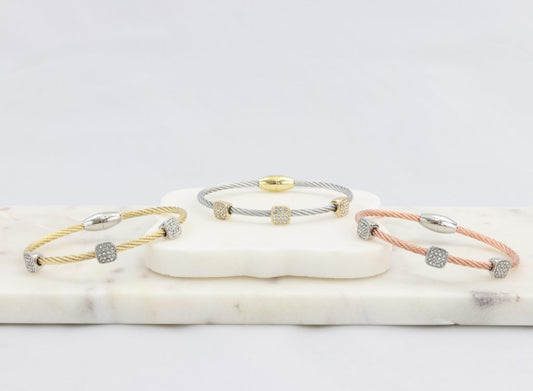 Twisted cable bracelet with square-clusters of diamond-like cubic zirconia stones  Ivy and Pearl Boutique Gold