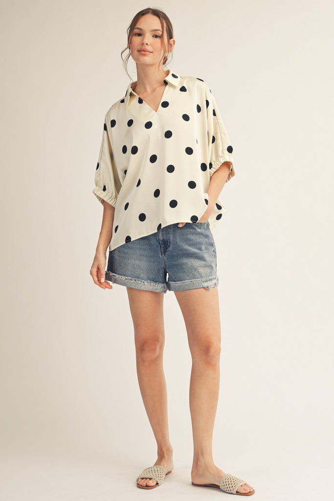 Drop shoulder polka dot satin top with collared neckline.