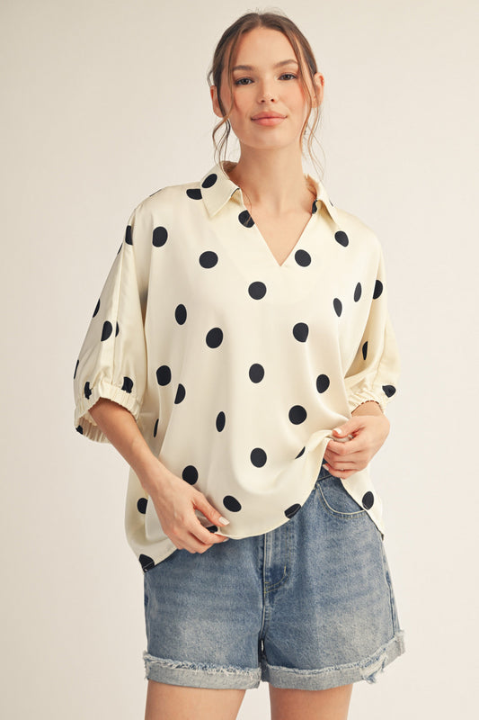 Drop shoulder polka dot satin top with collared neckline.