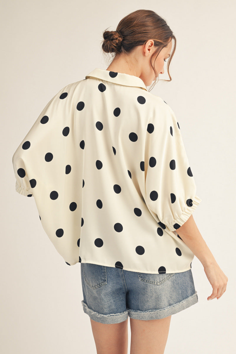 Drop shoulder polka dot satin top with collared neckline.