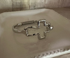 Cross hinged metal bracelet