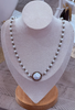 Faux pearl necklace with mother-of-pearl cabochon