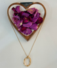 Gold toned necklace w/ oval pendant