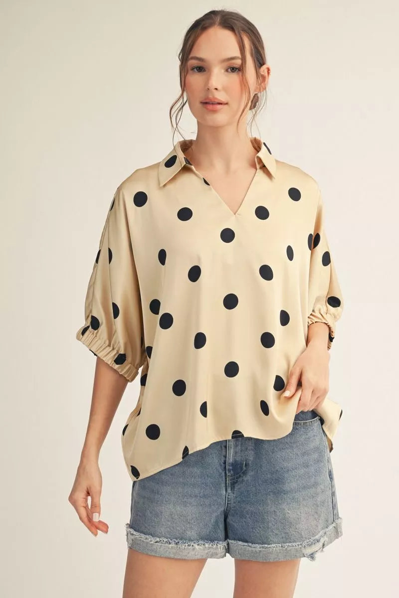 Drop shoulder polka dot satin top with collared neckline.