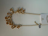 Golden stones on golden loops necklace