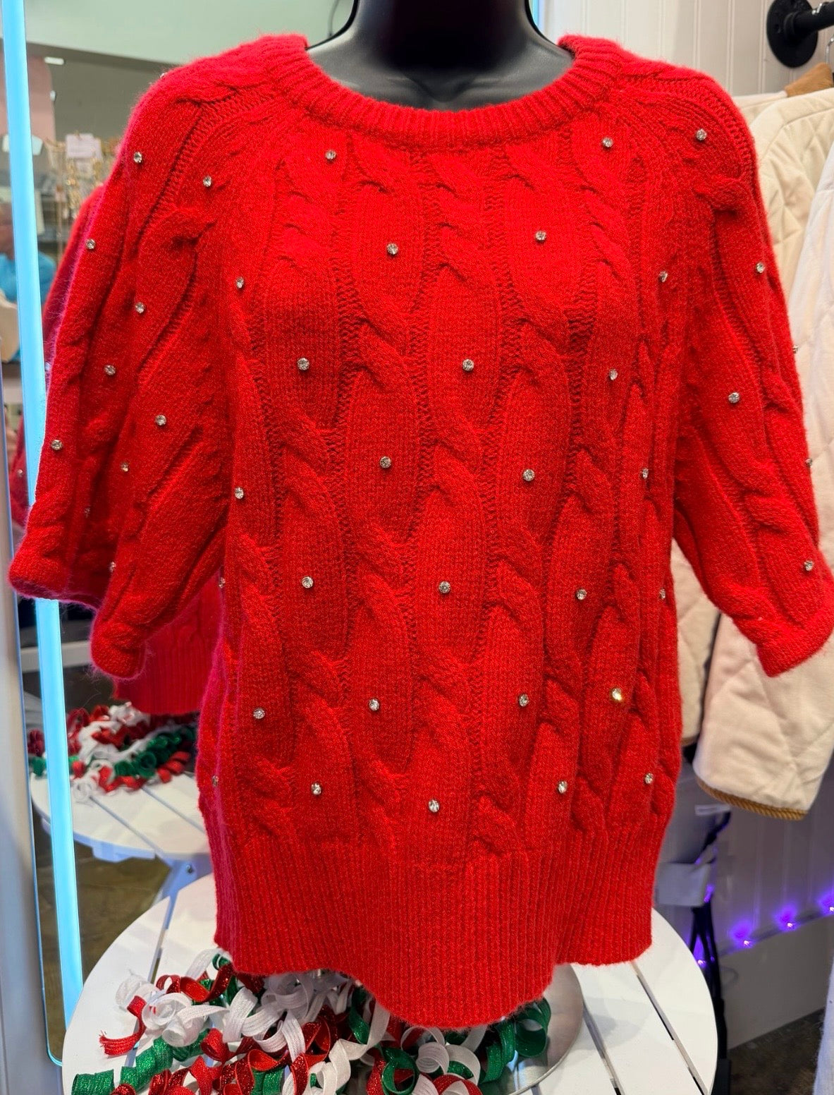 Solid short sleeve sweater knit top featuring cable knit with pearl accents