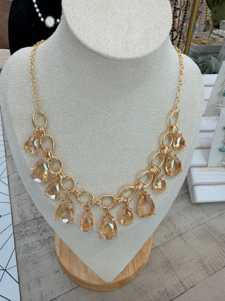 Golden stones on golden loops necklace