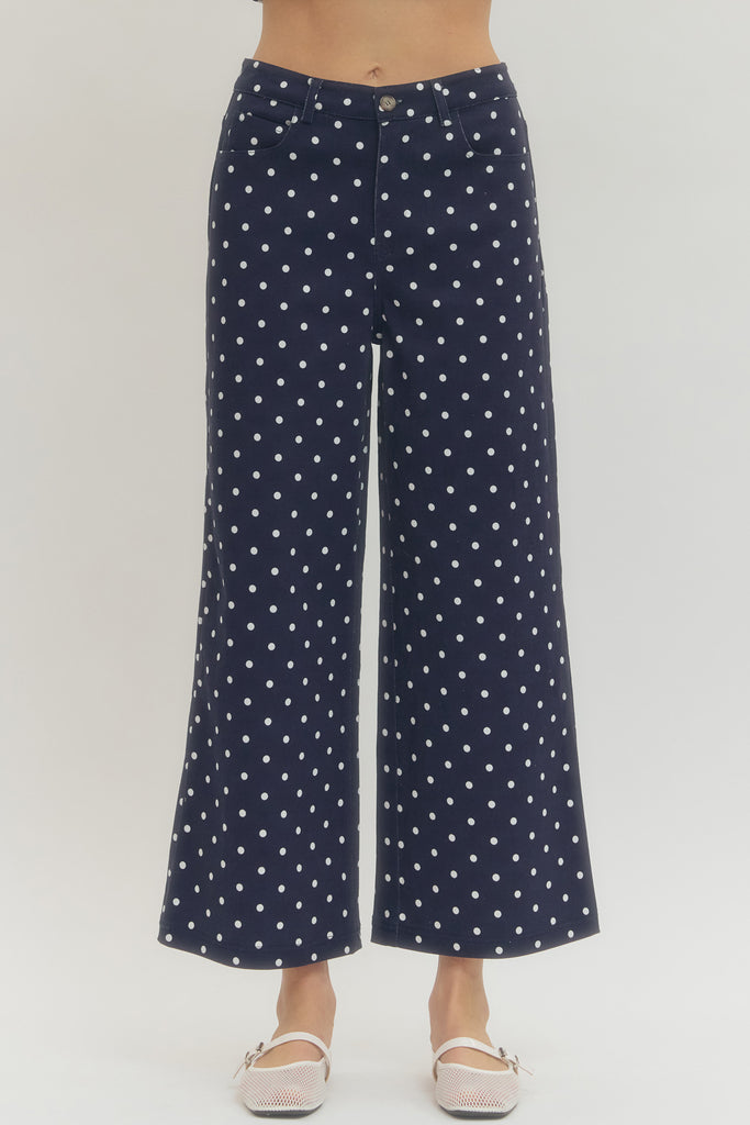 Polka dot wide leg pants featuring button and zip-fly closure at front