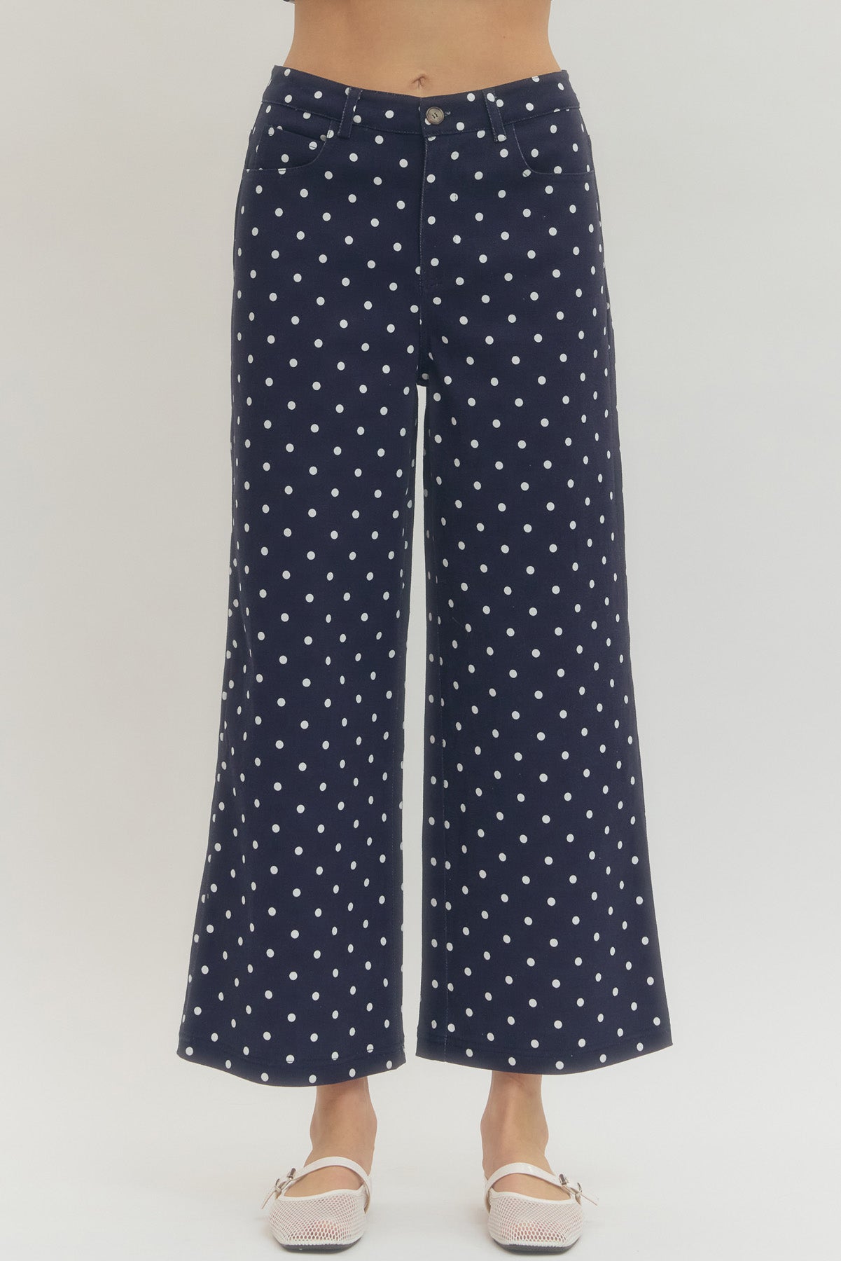 Polka dot wide leg pants featuring button and zip-fly closure at front