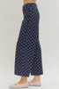 Polka dot wide leg pants featuring button and zip-fly closure at front