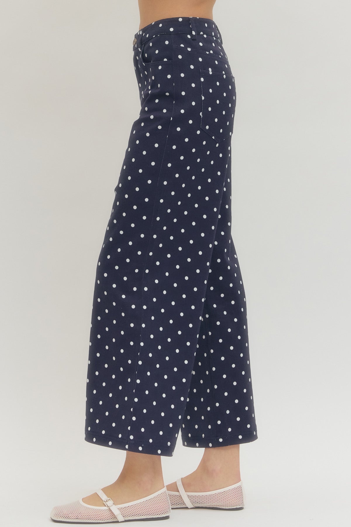 Polka dot wide leg pants featuring button and zip-fly closure at front