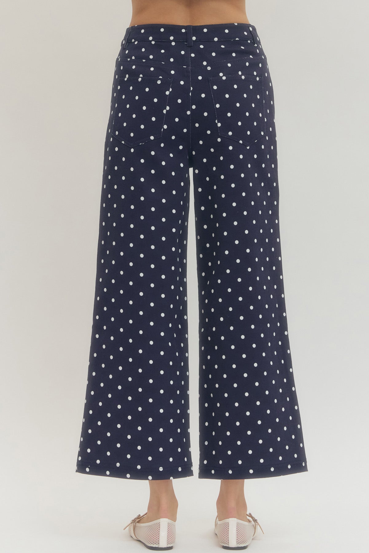 Polka dot wide leg pants featuring button and zip-fly closure at front