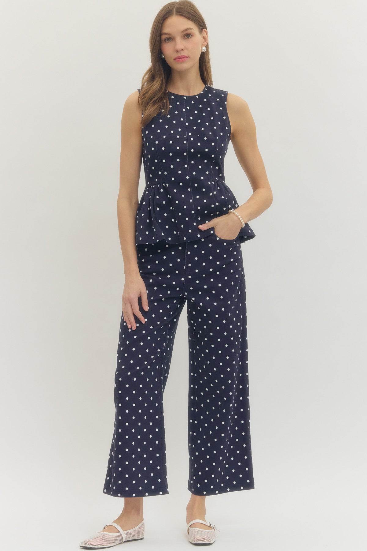 Polka dot wide leg pants featuring button and zip-fly closure at front