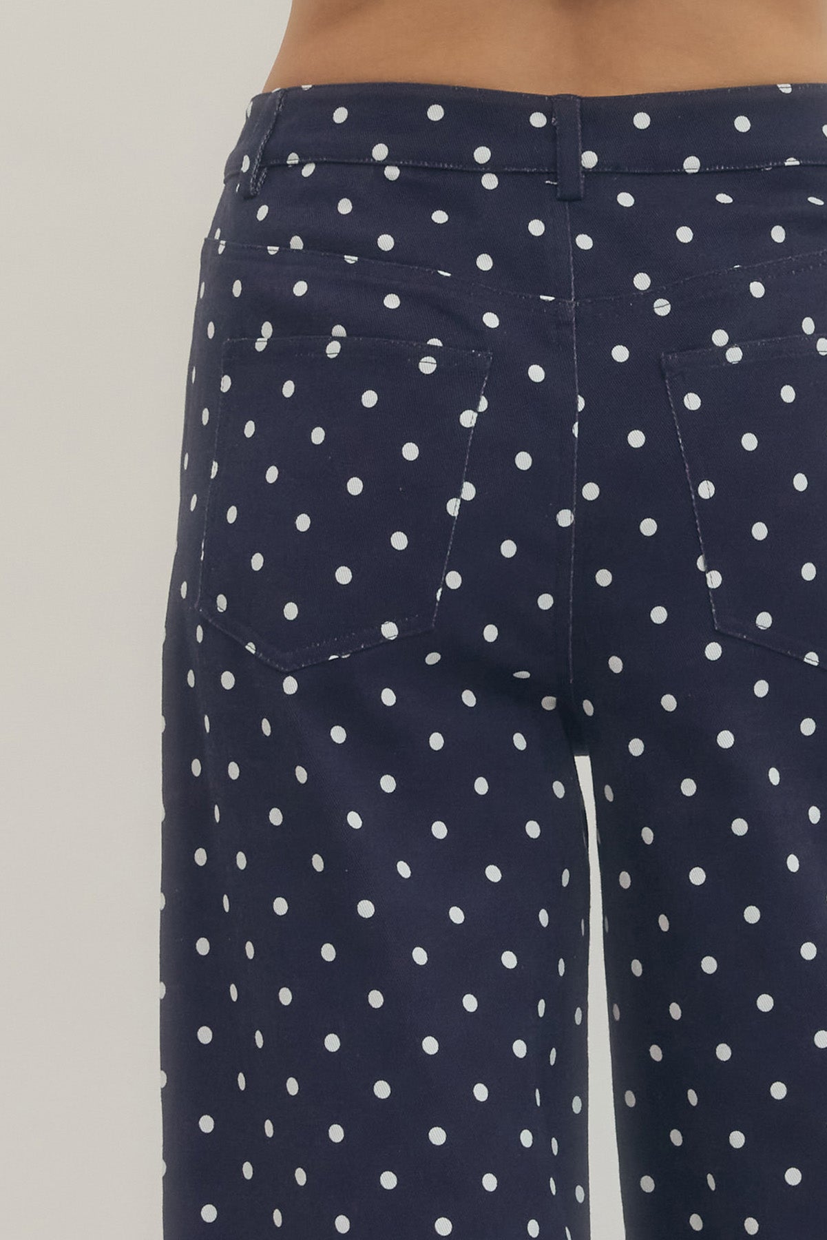 Polka dot wide leg pants featuring button and zip-fly closure at front