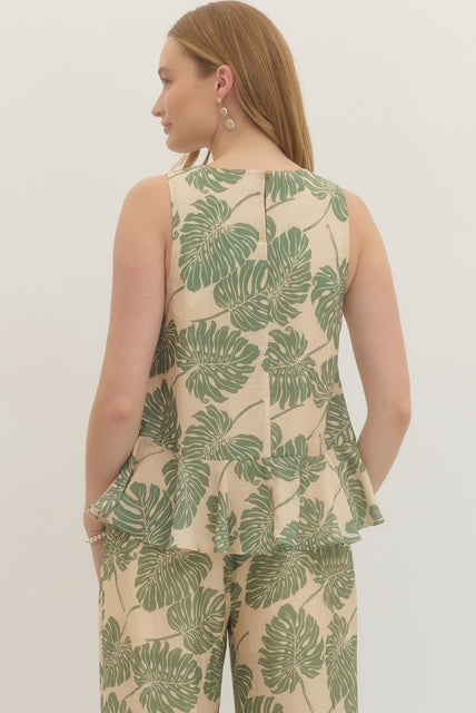 Botanical print sleeveless top featuring ruffle hem detail