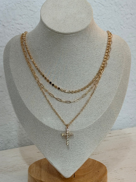 Layered chain and disc necklace with faux diamond cross