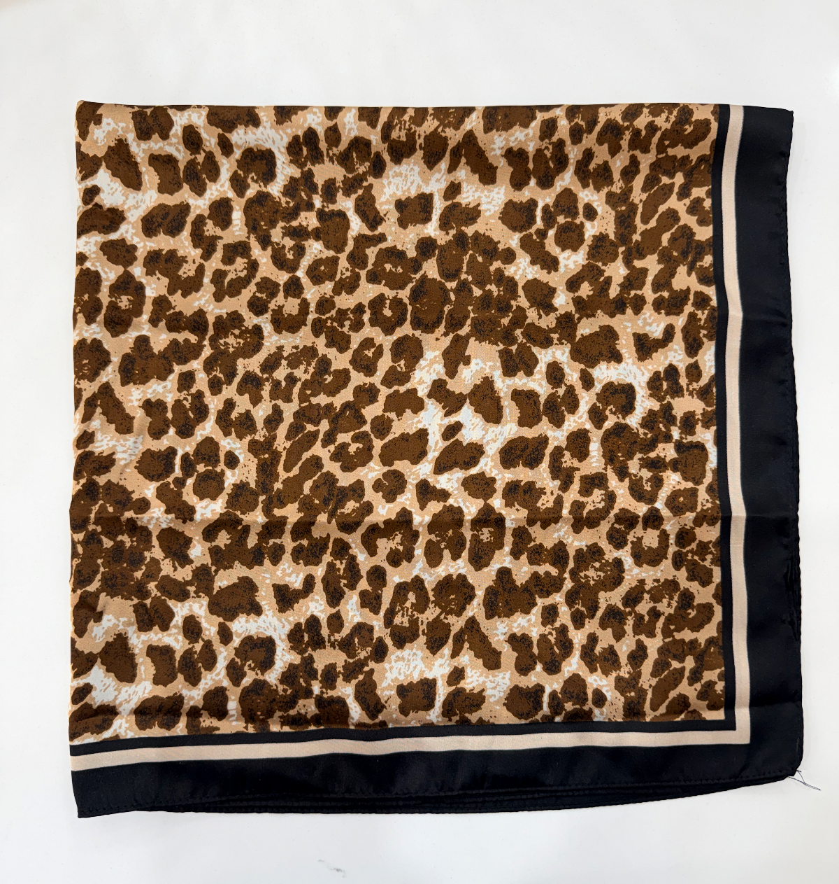 A square scarf with a brown and beige leopard print pattern and a solid black border, laid flat on a white background.