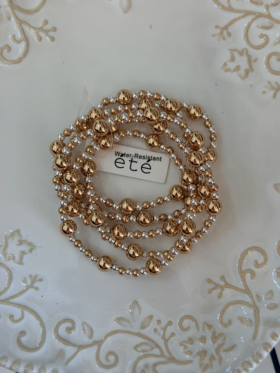 Water resistant gold and silver variable size beads stacked bracelet