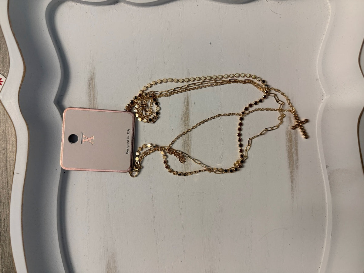 Layered chain and disc necklace with faux diamond cross