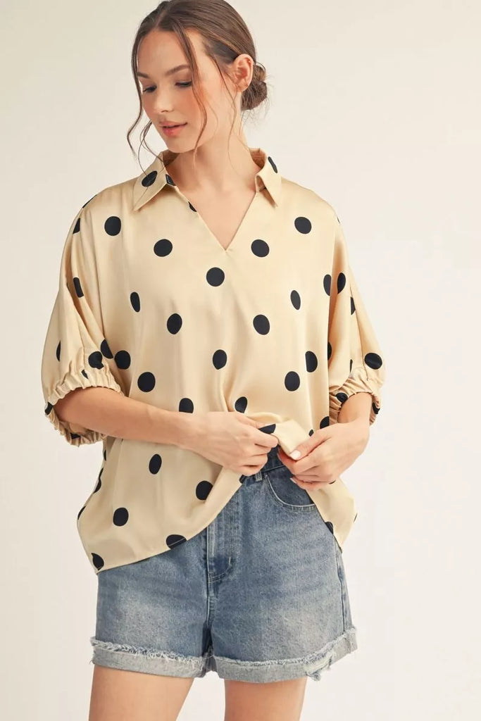 Drop shoulder polka dot satin top with collared neckline.
