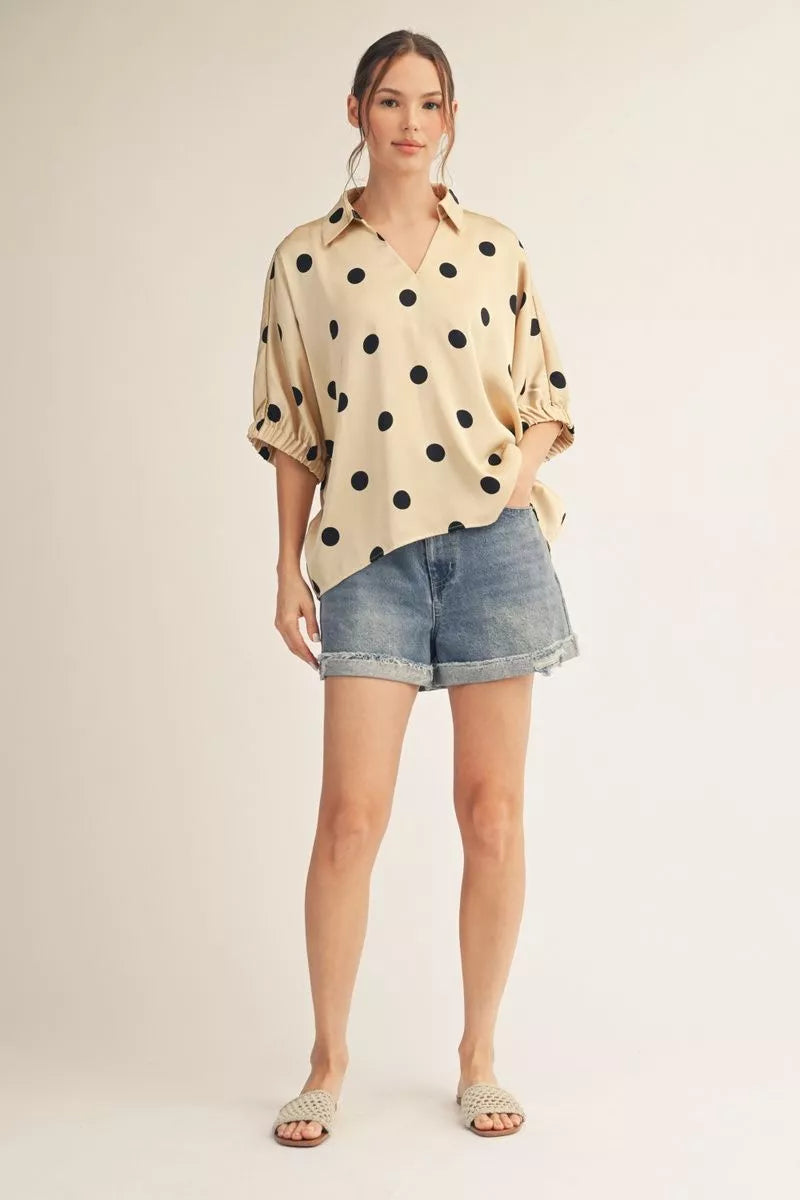 Drop shoulder polka dot satin top with collared neckline.