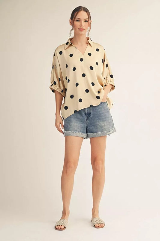 Drop shoulder polka dot satin top with collared neckline.