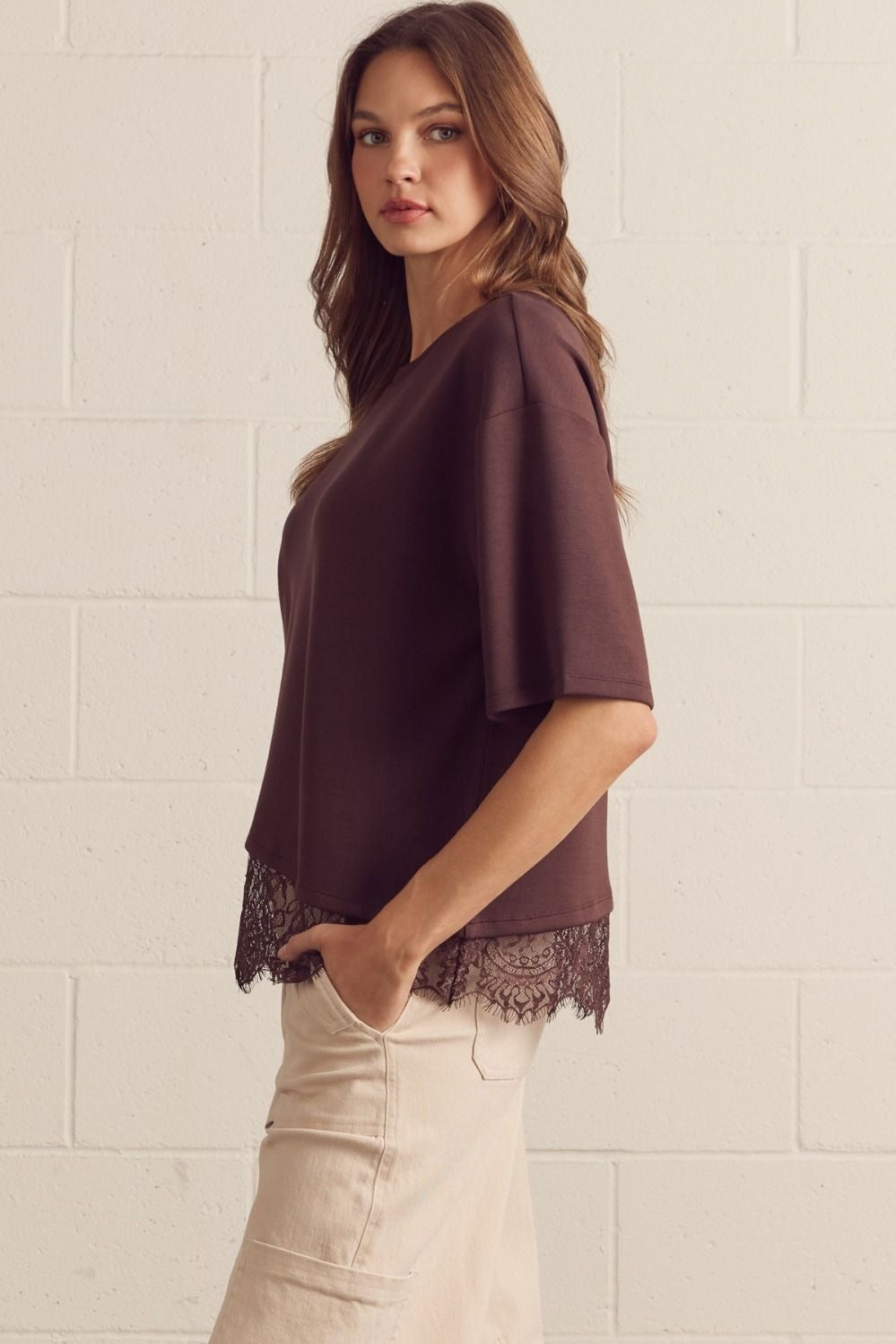 Solid short sleeve knit top featuring scallop lace hem detail