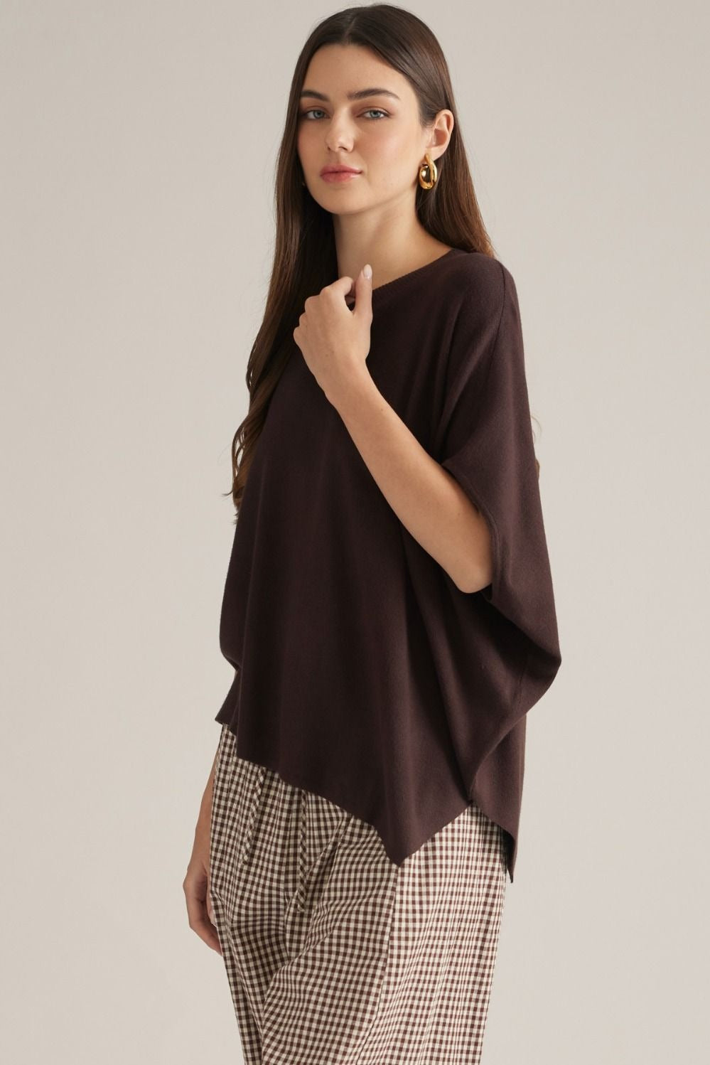 Solid short poncho sleeve sweater top with a round neckline