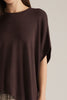 Solid short poncho sleeve sweater top with a round neckline