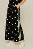 Drop shoulder front zip up polka dot top and bottom with color rib band accent, mock neck