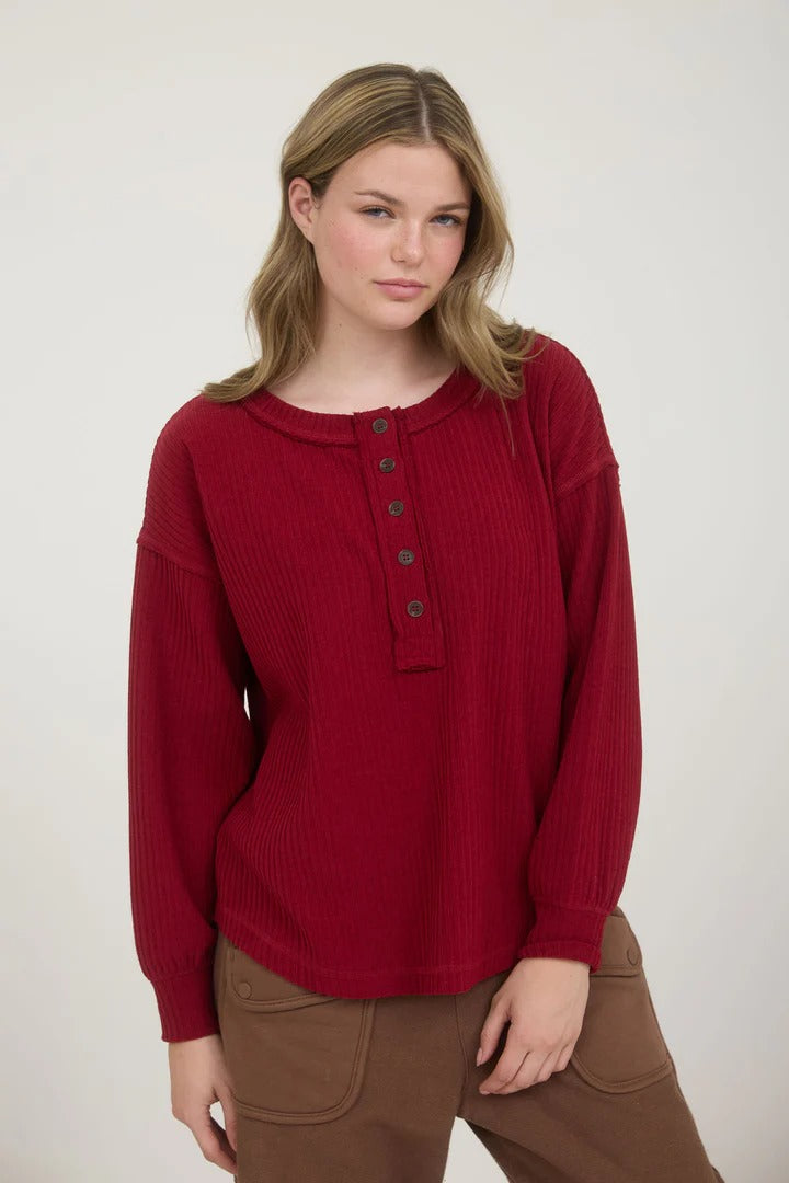 Ribbed henley long sleeve exposed seam knit top