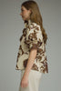 Printed short puff sleeve top featuring button closure at front