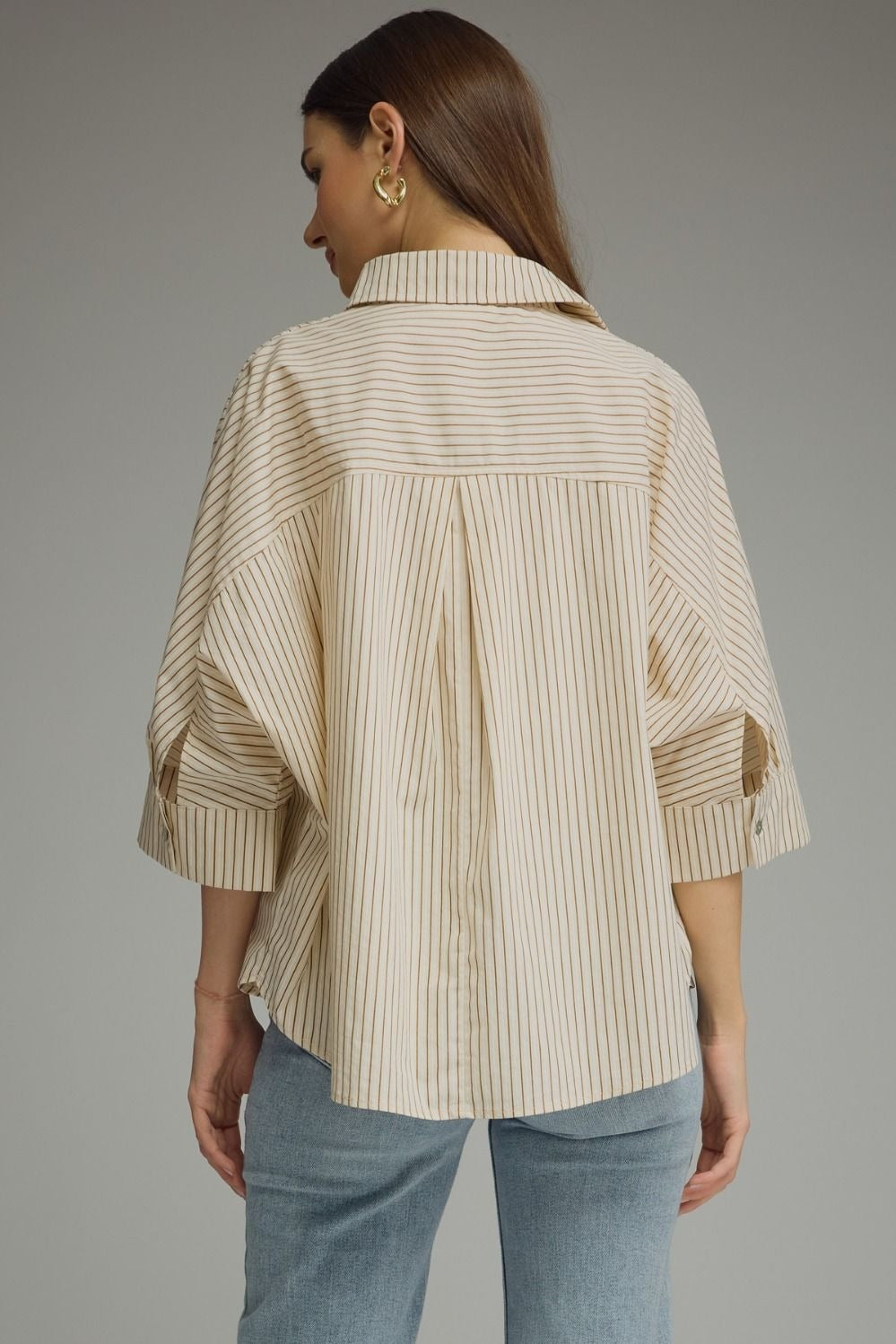 Stripe ¾ sleeve top featuring front pocket detail